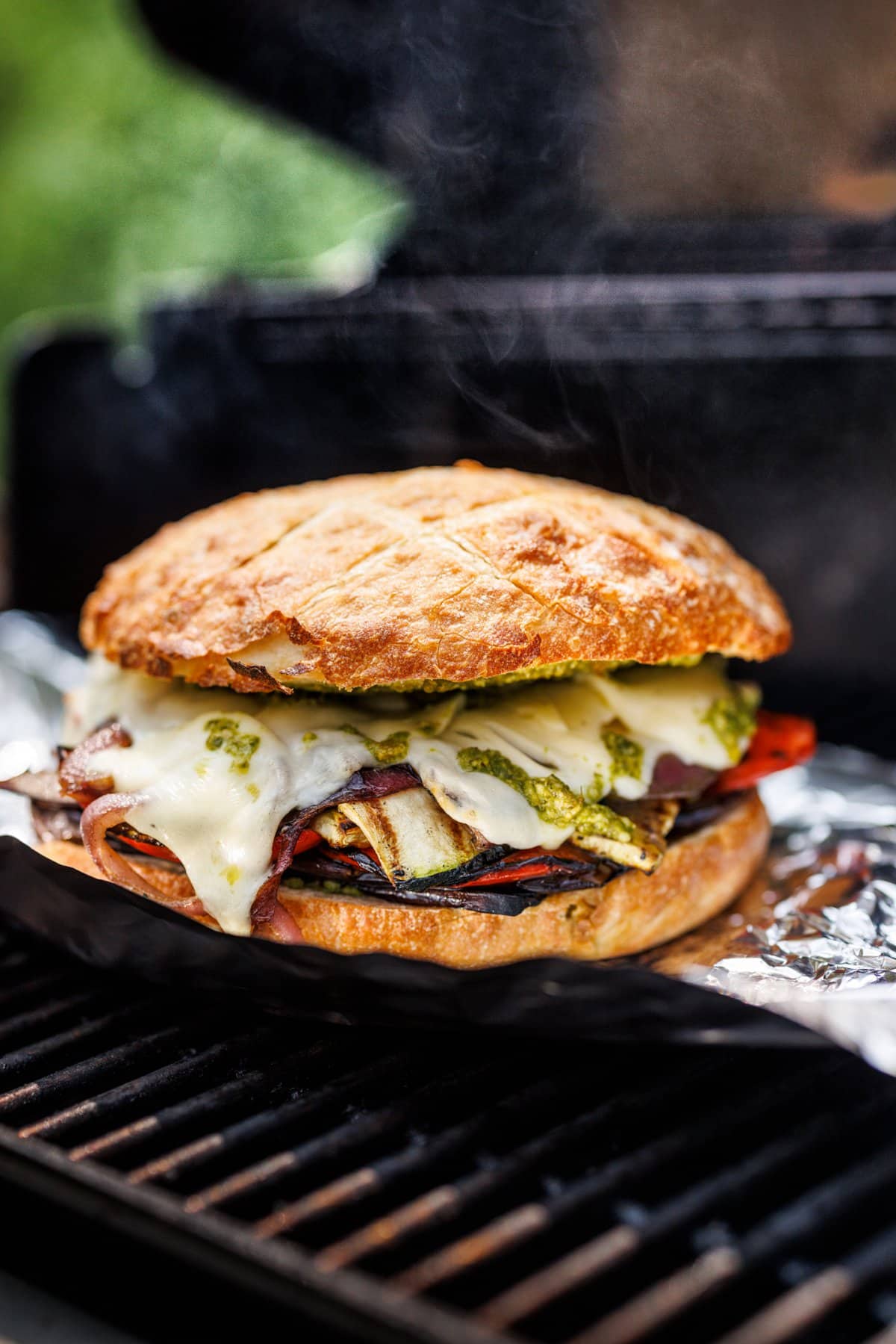 Grilled vegetable sandwich with pesto and mozzarella on the grill.