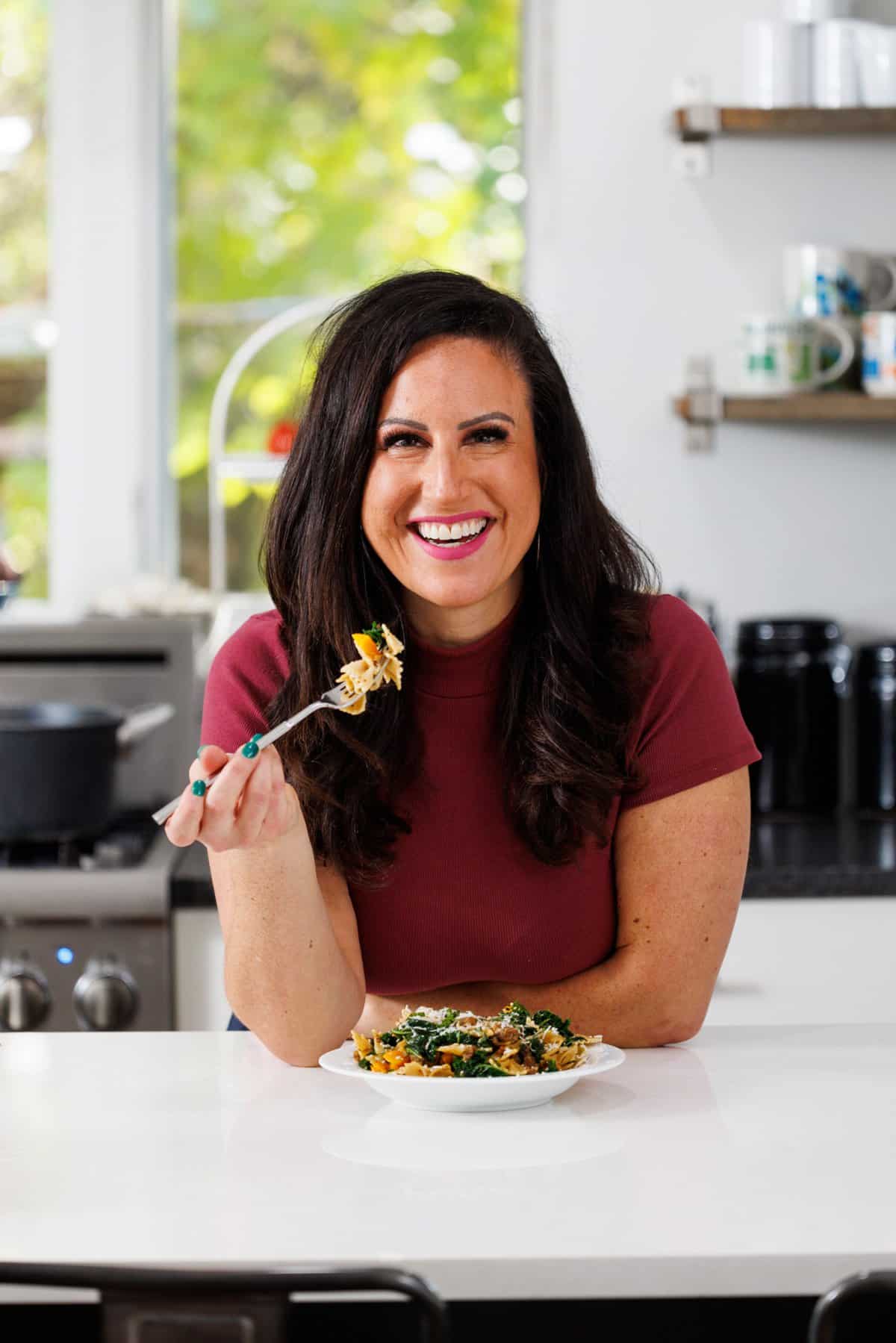 Liz eating sausage and butternut squash pasta.