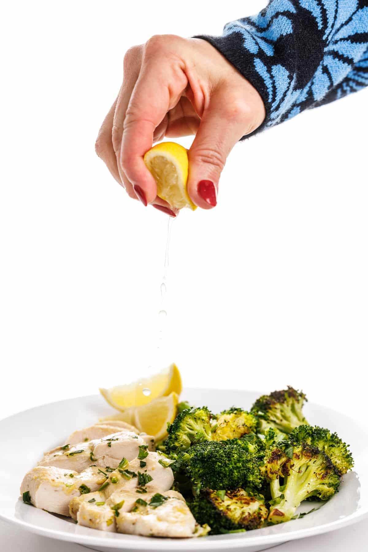 Garnishing chicken and broccoli for whole 30 chicken recipes.