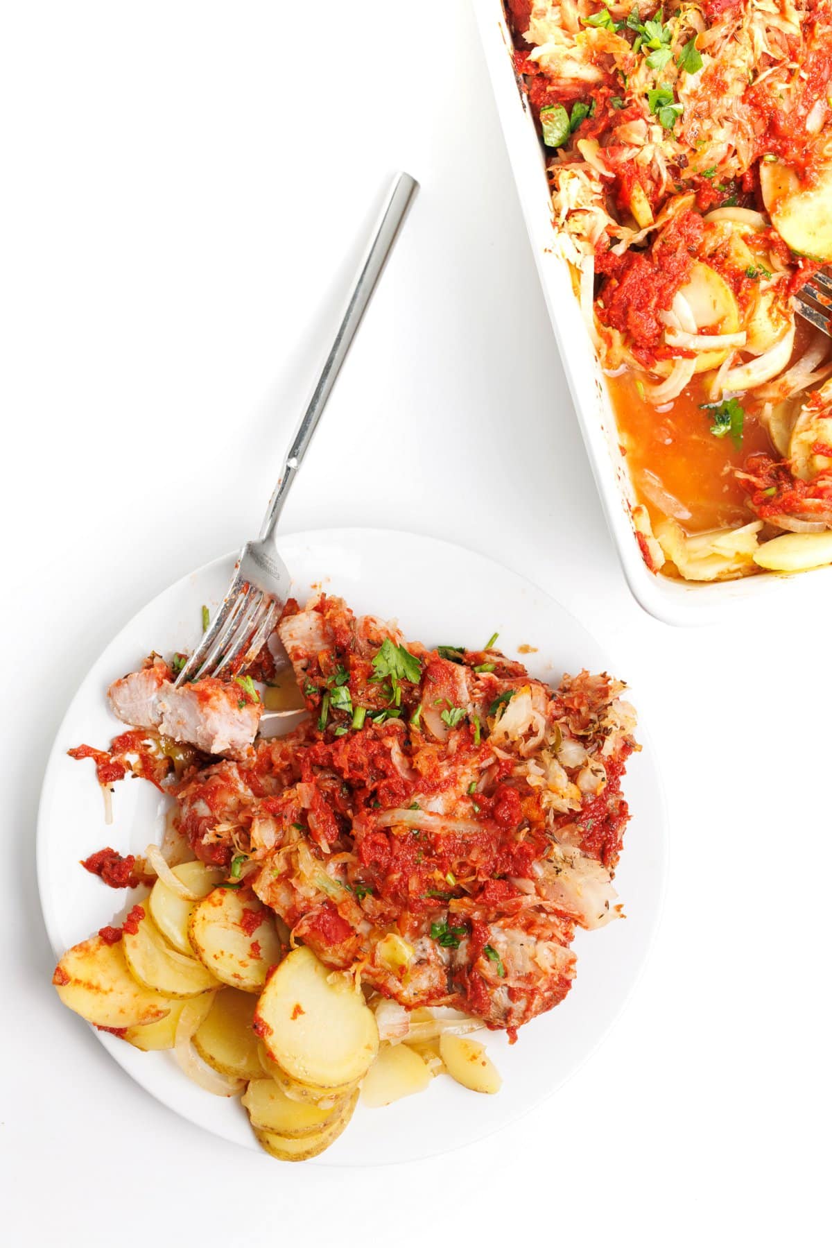 Oven baked pork chops with potatoes and sauerkraut.