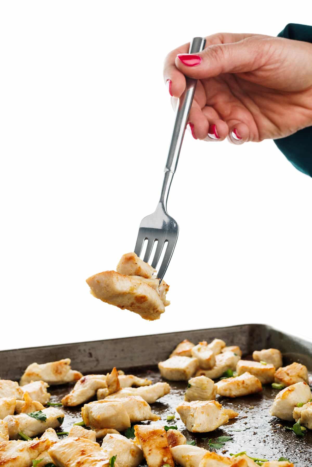 Forkful of sheet pan Lebanese shish tawook chicken.