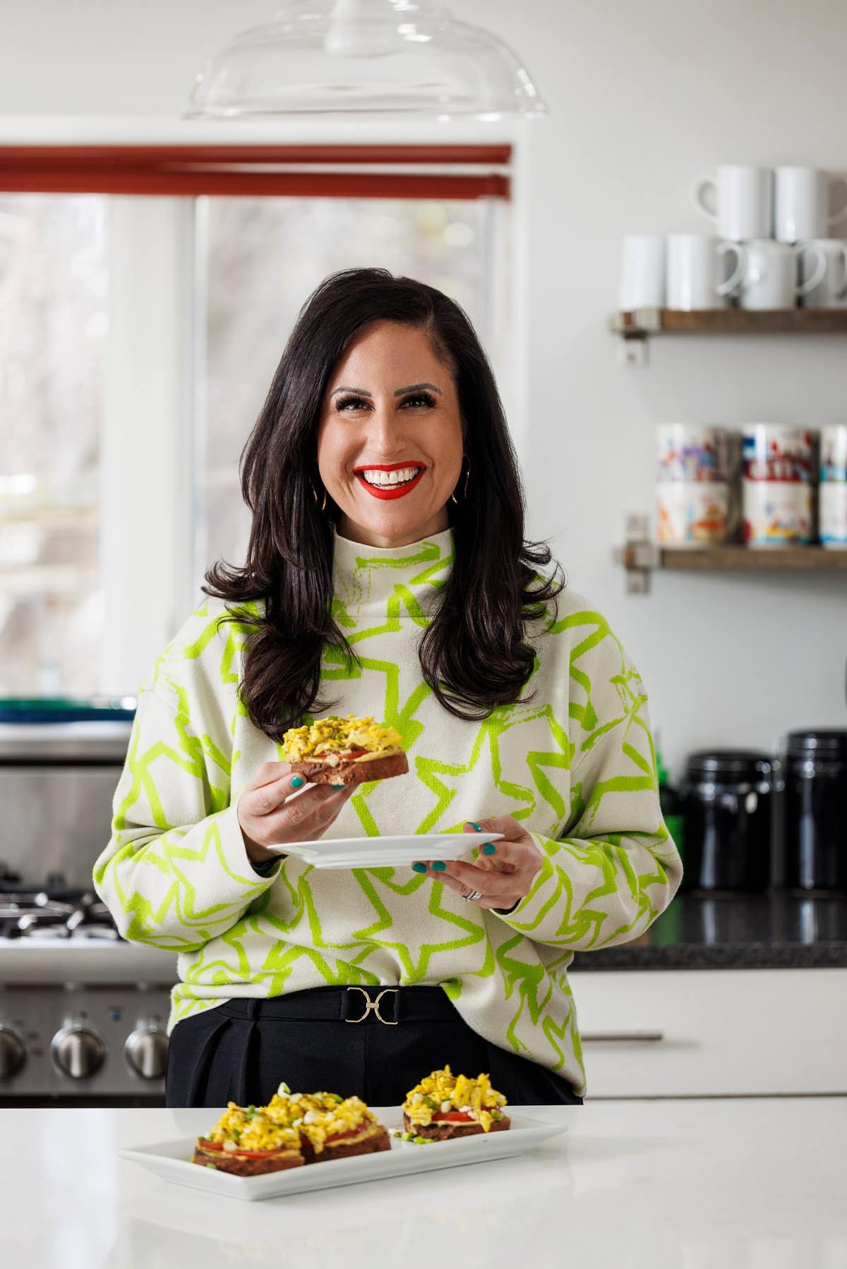 Liz eating hummus toast with scrambled eggs.