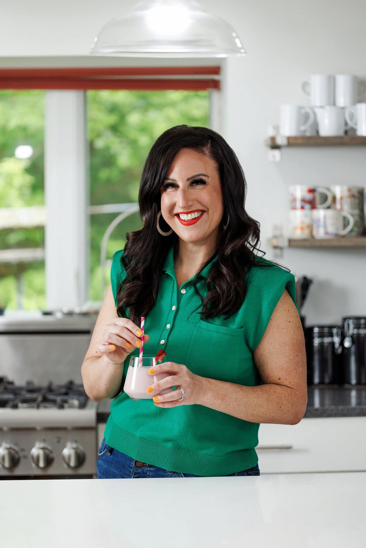 Liz drinking a strawberry protein smoothie.