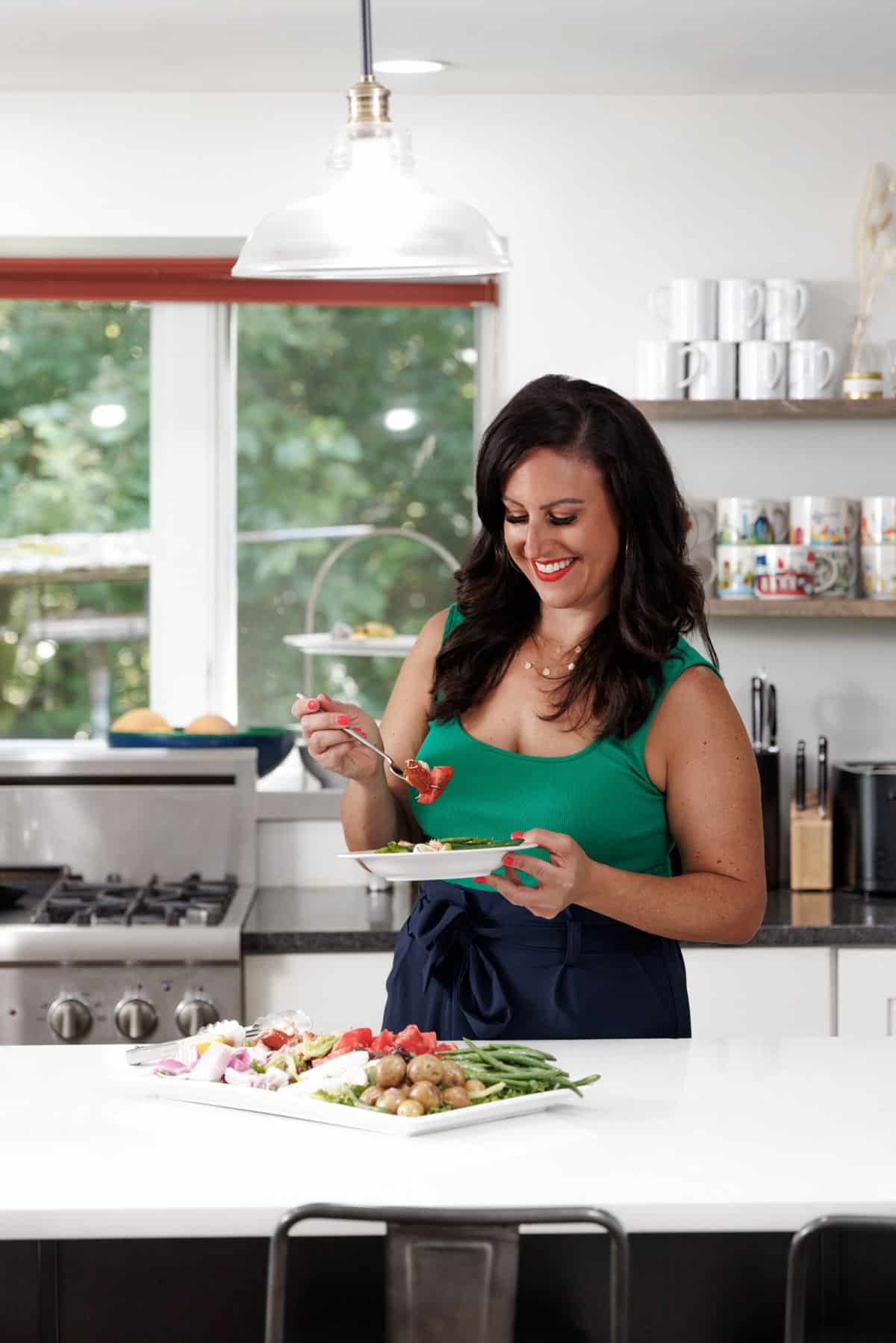Liz eating a smoked salmon nicoise salad.