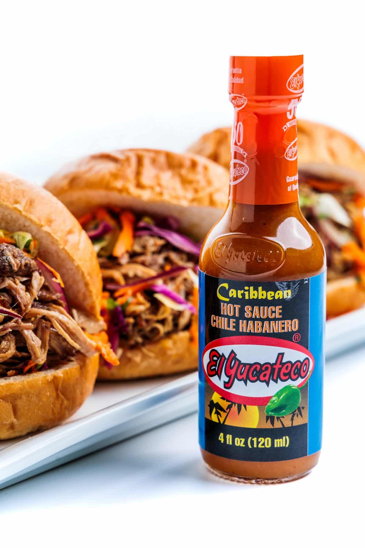 Pulled pork sliders with cabbage slaw and El Yucateco hot sauce.