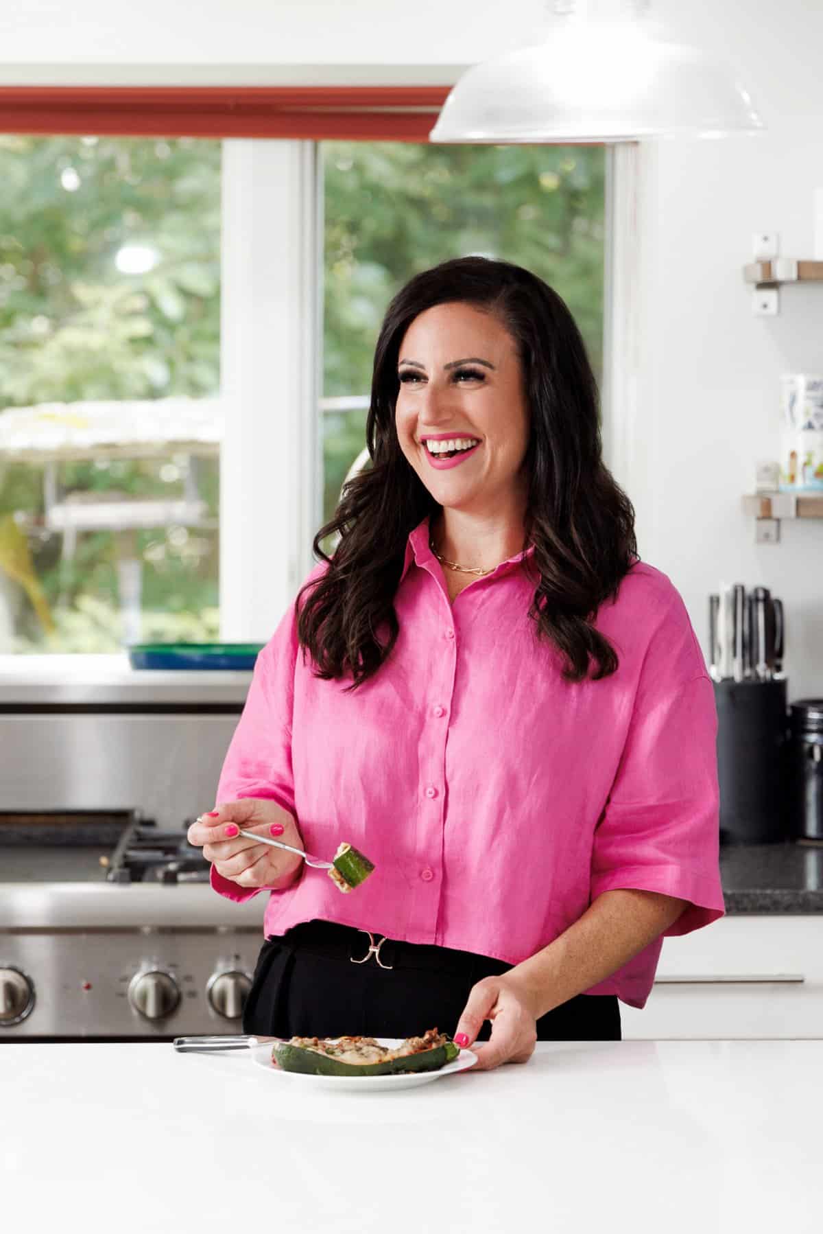 Liz eating zucchini pizza boats.