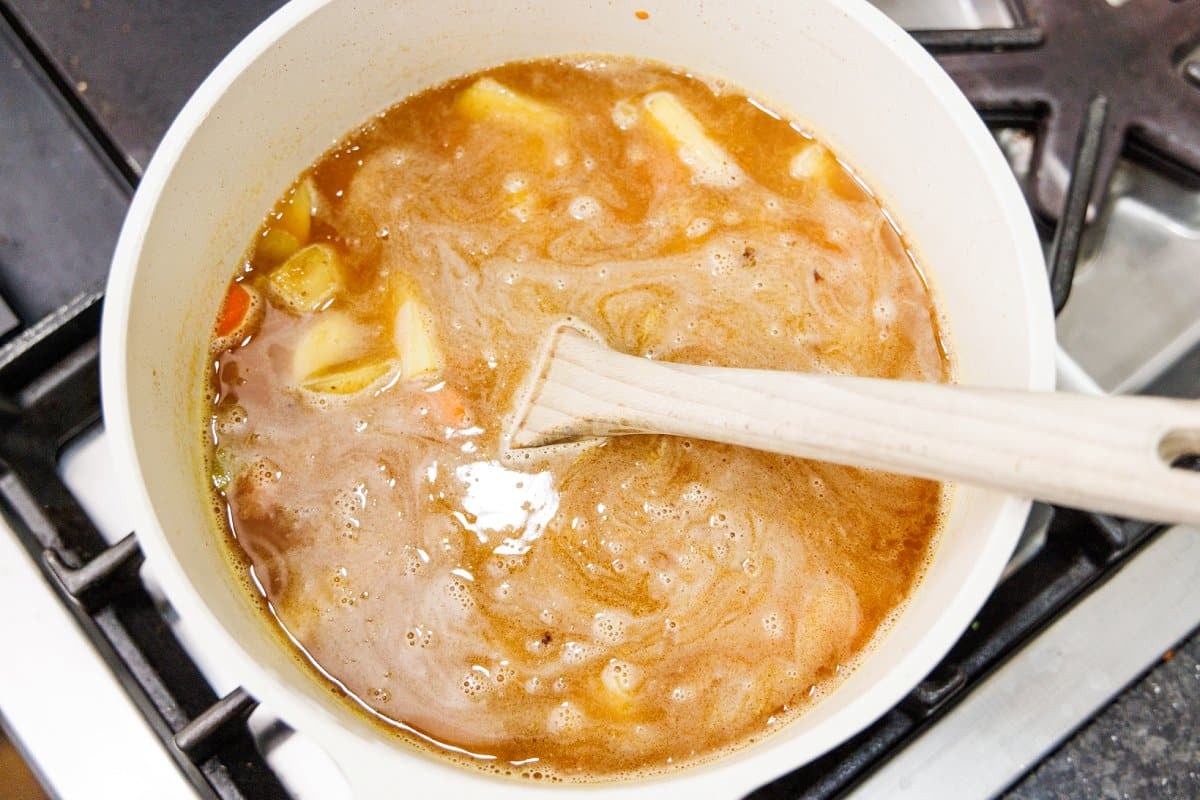 Stirring cooked ren lentil soup.