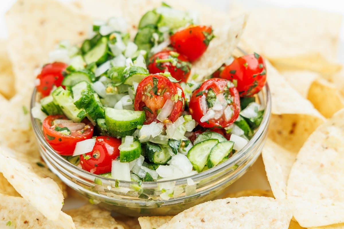 Cucumber pico de gallo in a small glass bowl.