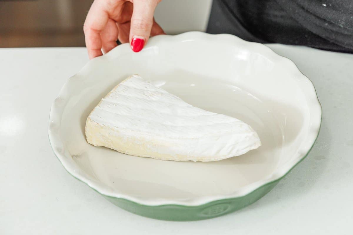 Brie wedge in a baking dish.
