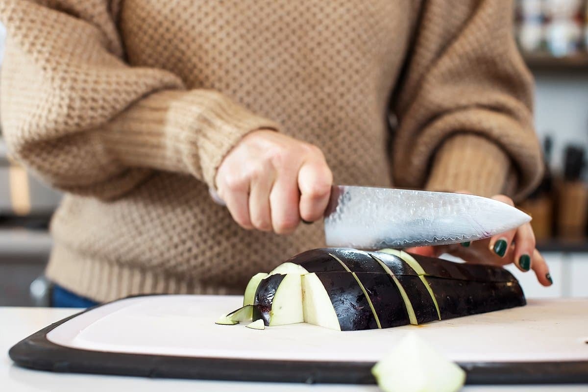 Liz cutting an eggplant into cubes.