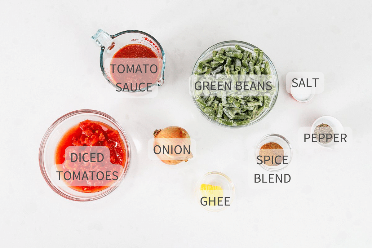 Labeled ingredients for Lebanese green beans with tomatoes on a white background.