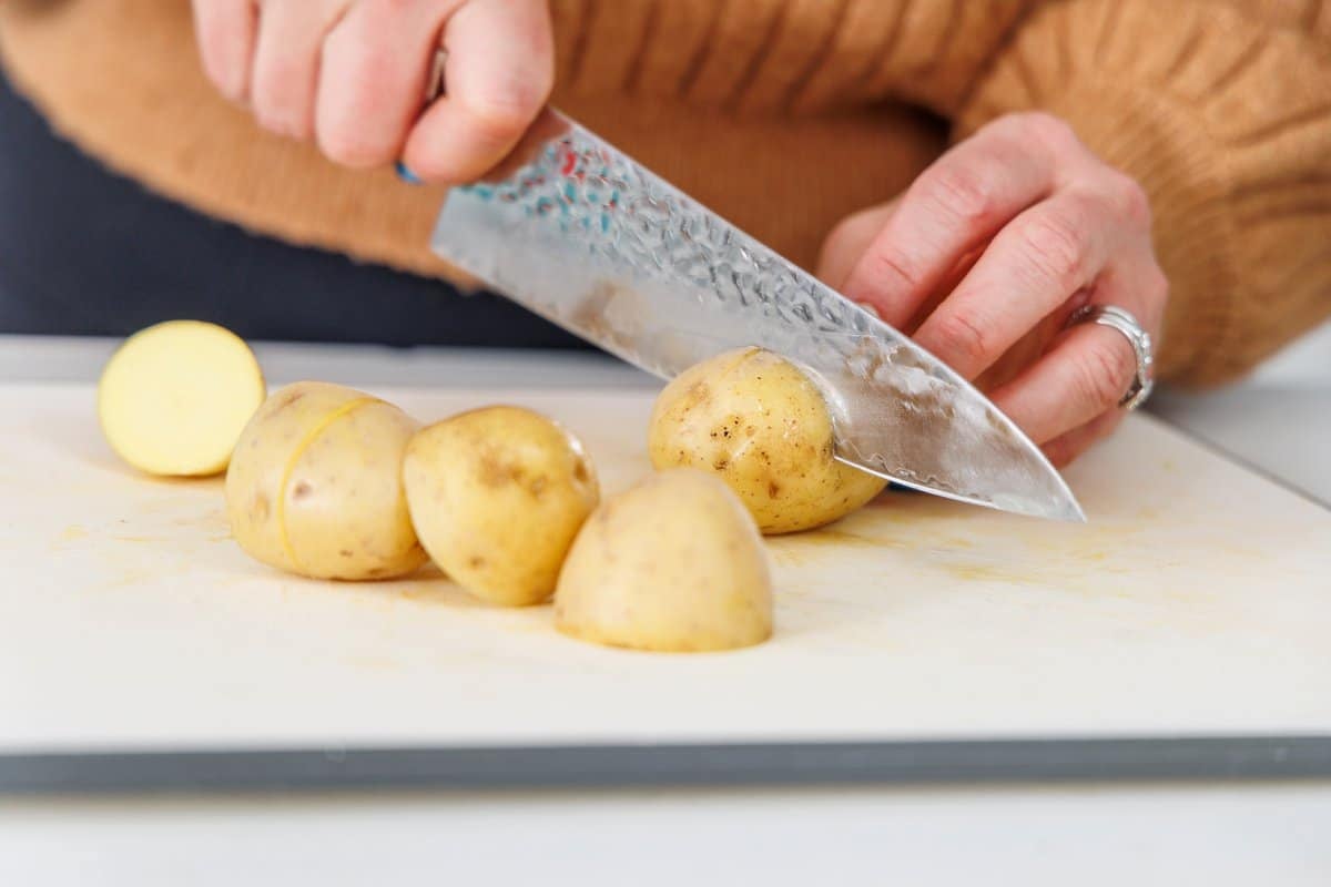 Liz cutting potatoes into quarters.