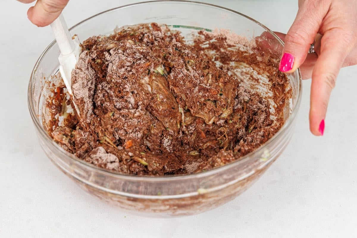 Mixing wet ingredients into dry ingredients a spatula.