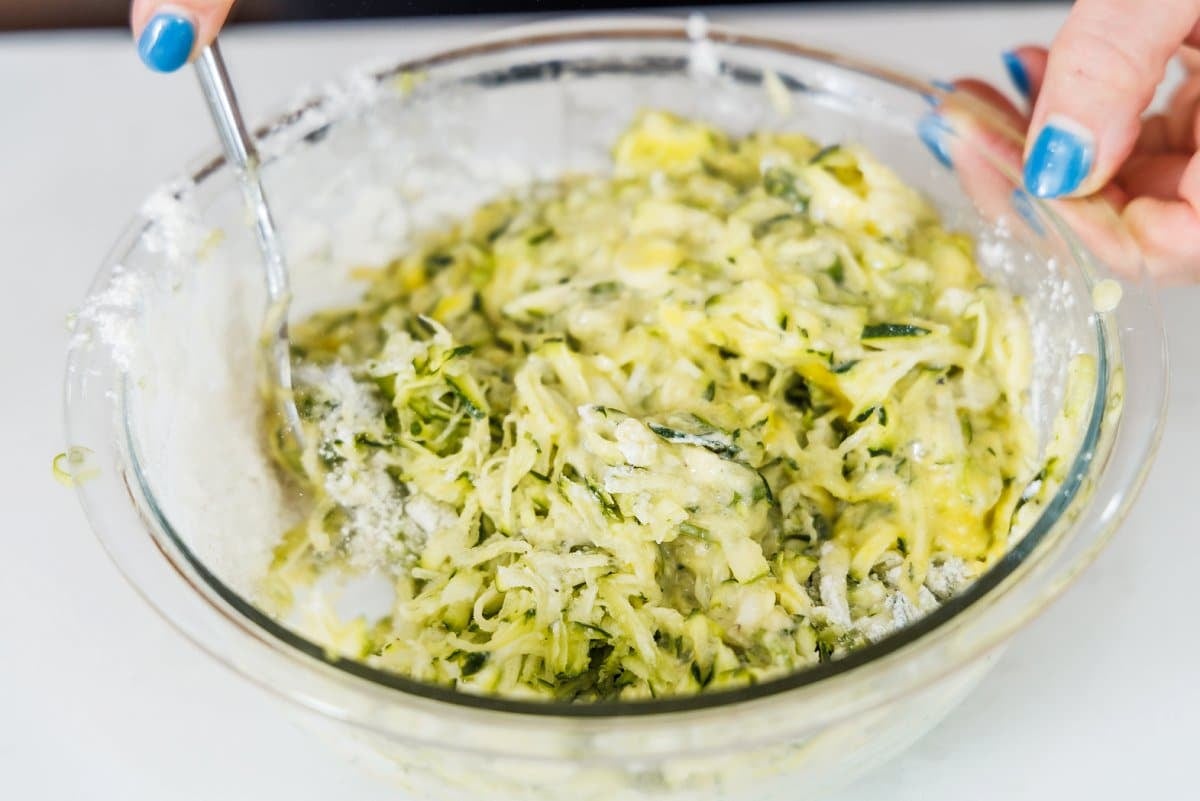 Mixing zucchini scallion pancake batter together.