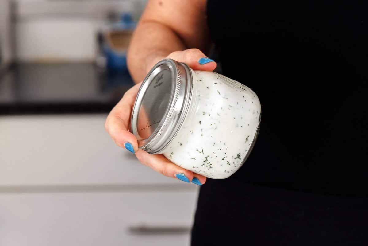 Shaking up 5-ingredient dill ranch in a mason jar.