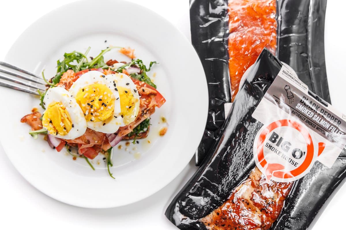 A plate of avocado salmon toast next to big o' smokehouse salmon.