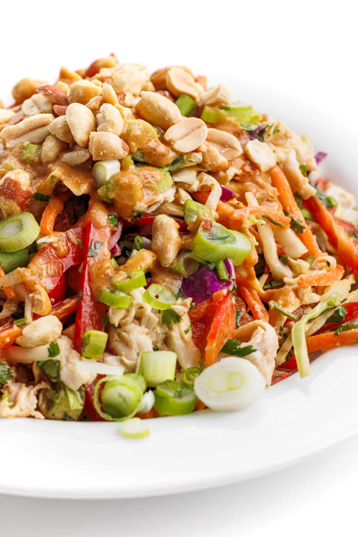 Healthy Asian chicken chopped salad topped with crushed peanuts.