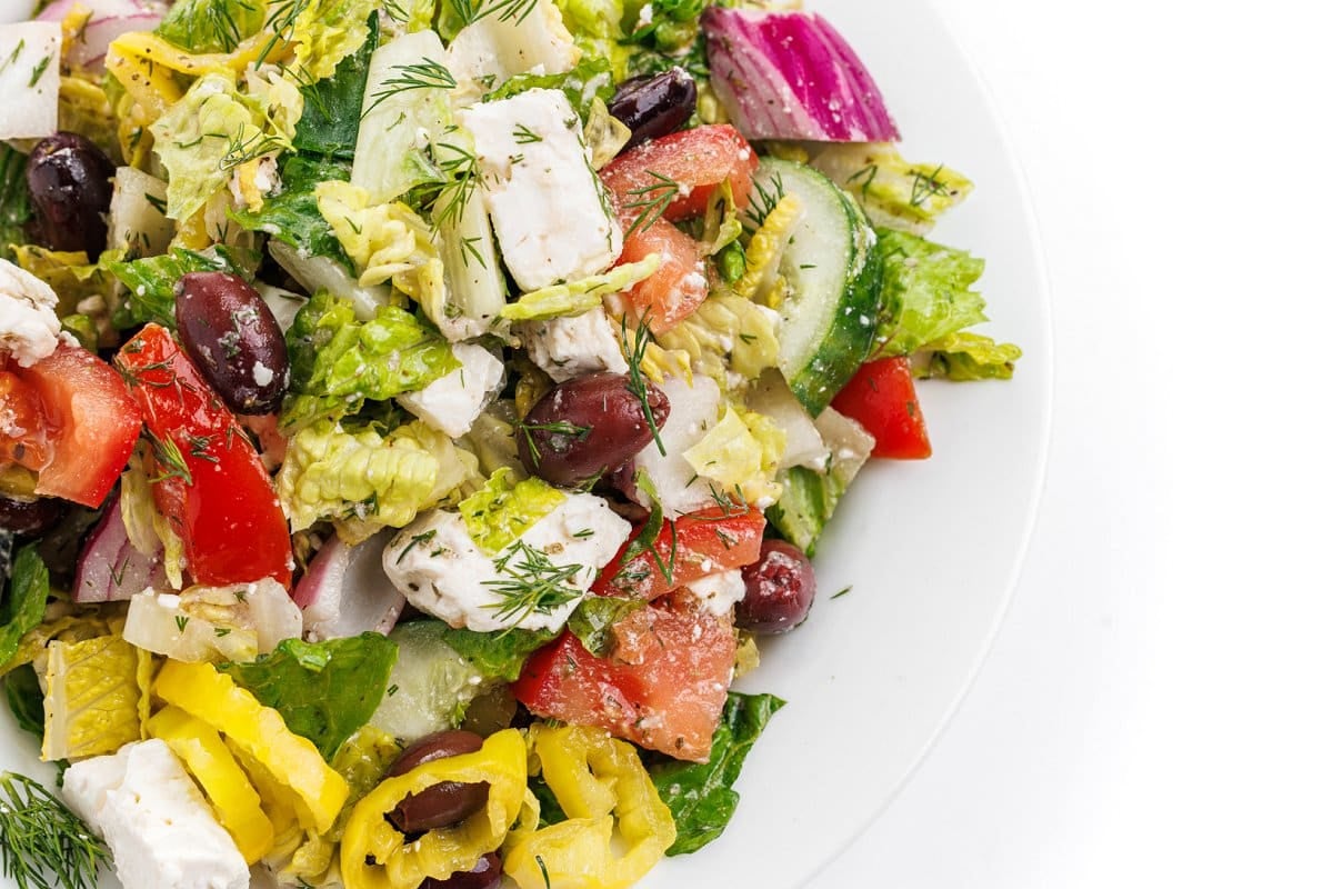 Traditional Greek salad topped with fresh dill.