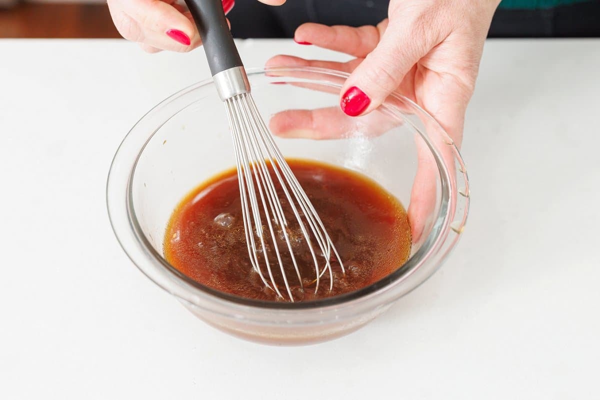 Whisking together stir-fry sauce.