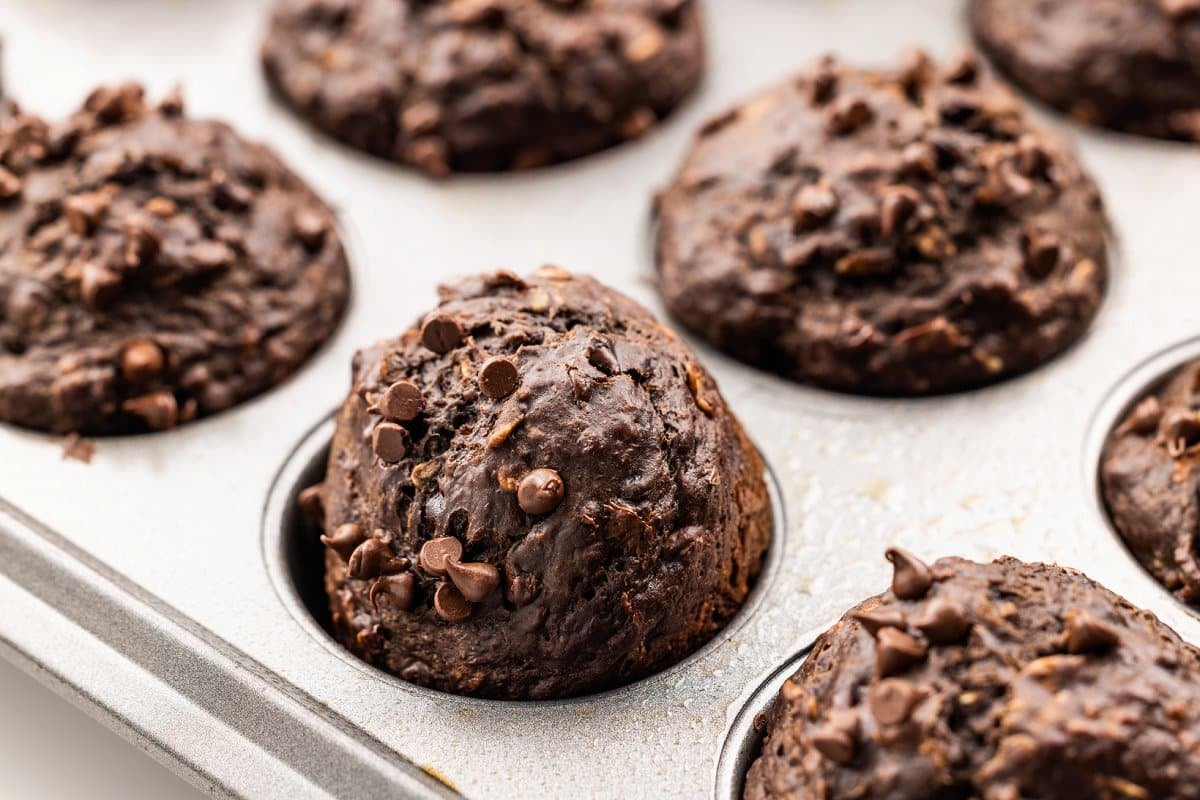 Chocolate banana oat muffins cooling in muffin tin.