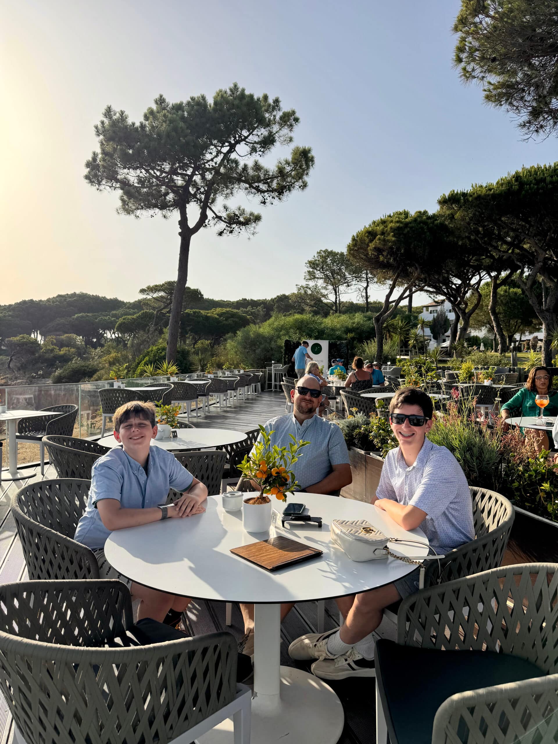 Rich and the boys sitting outside at the Pine Cliffs resort in Alburfeira, Portugal.