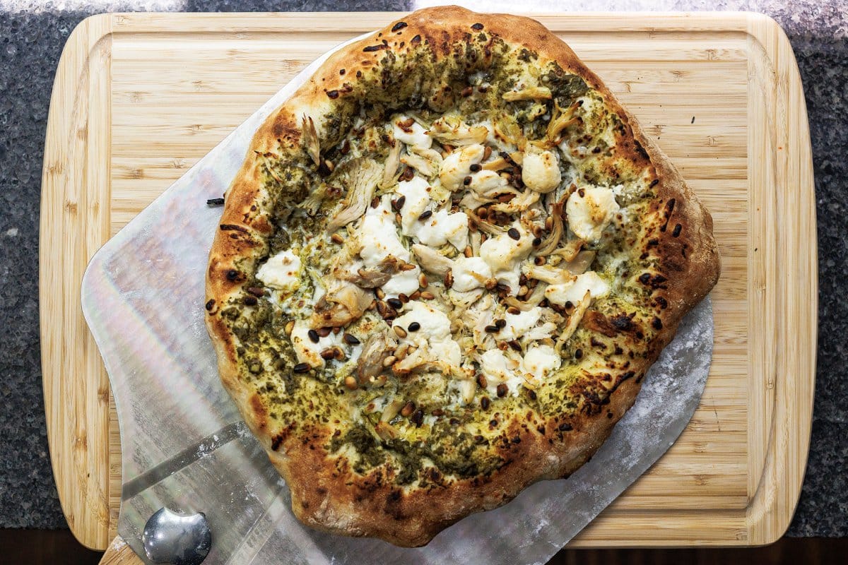 Cooked pesto chicken pizza removed from the oven.