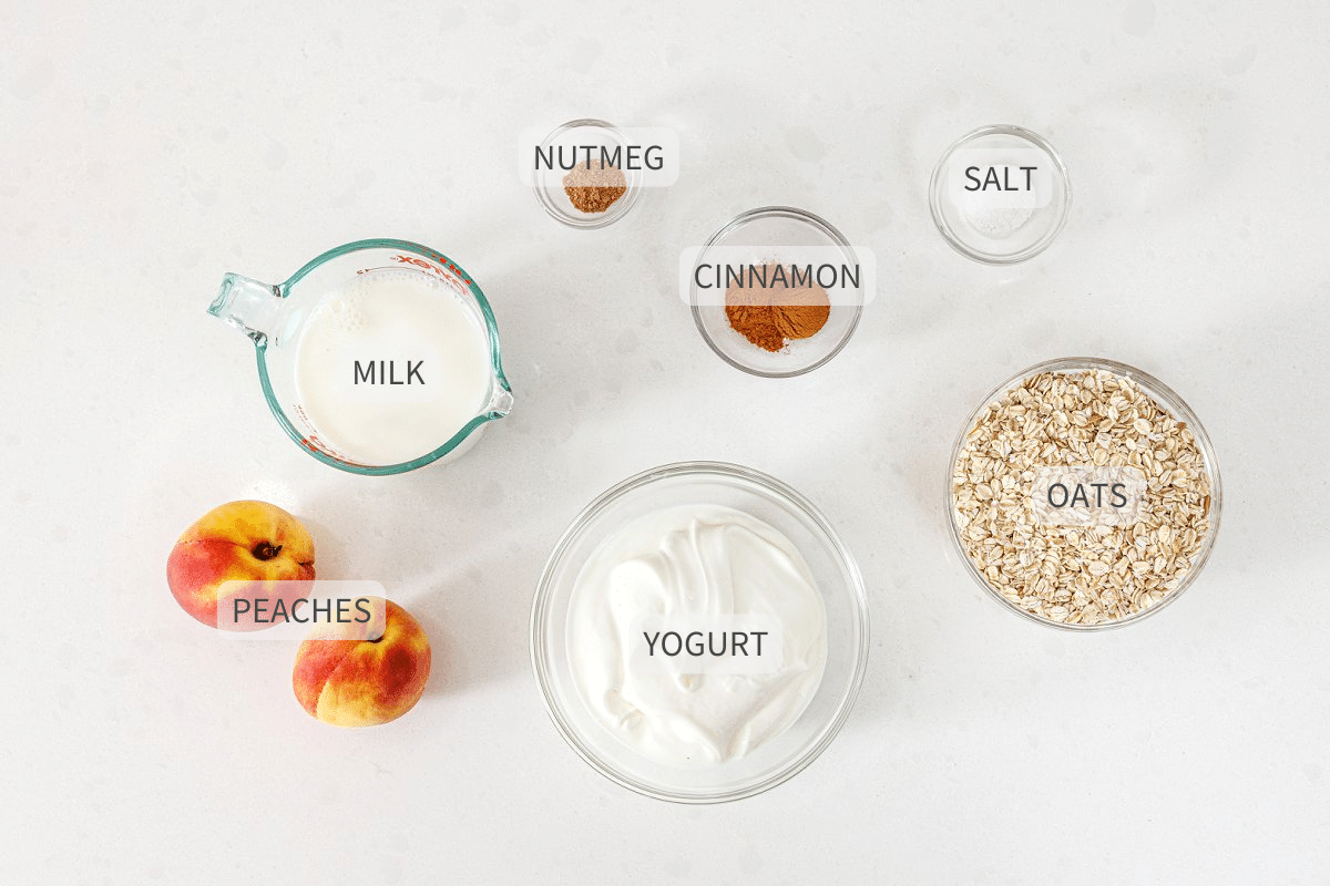 Labeled ingredients for peaches and cream overnight oats on a white counter.