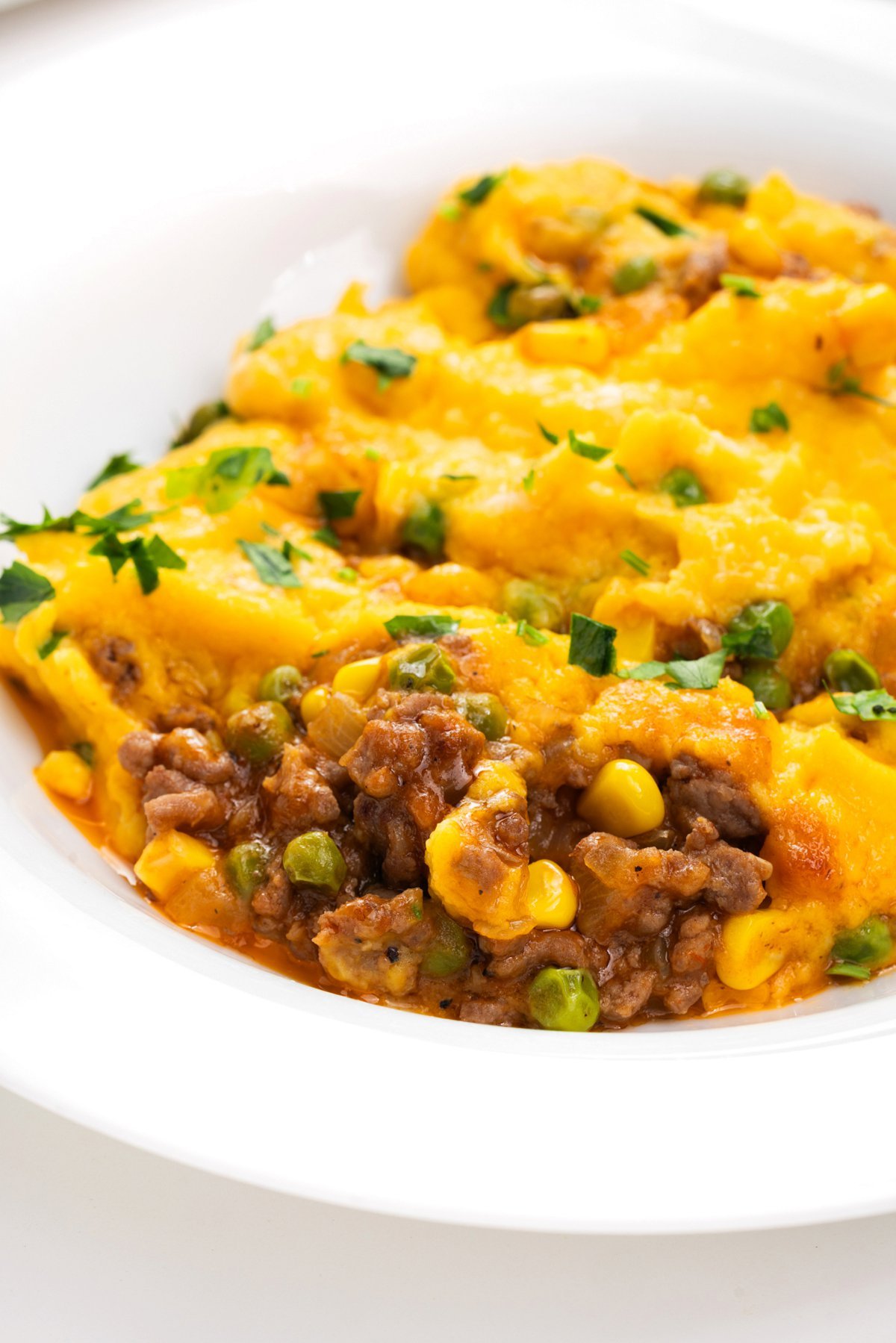 Portion of shepherd's pie with butternut squash in a bowl.