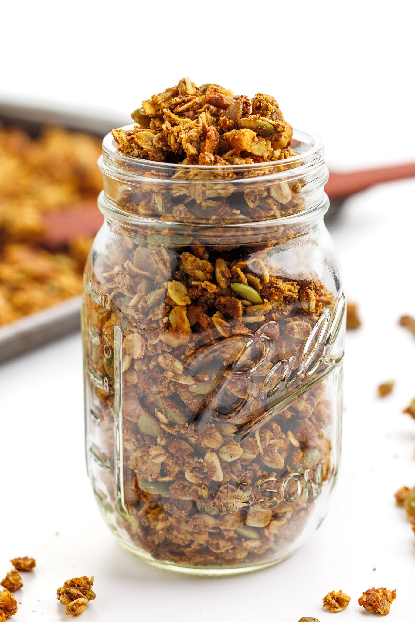 High protein pumpkin spice granola  piled high in a mason jar.