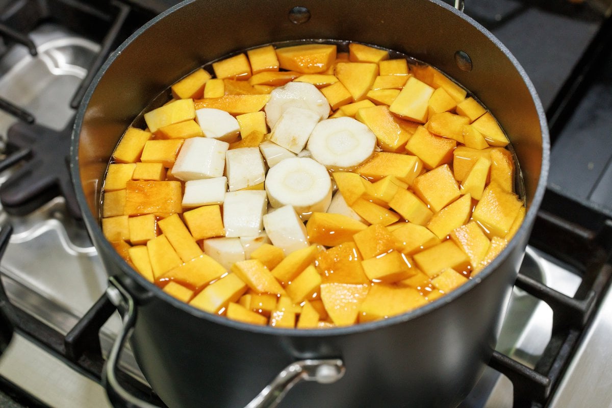 Butternut squash and parsnips in a large pot of water.