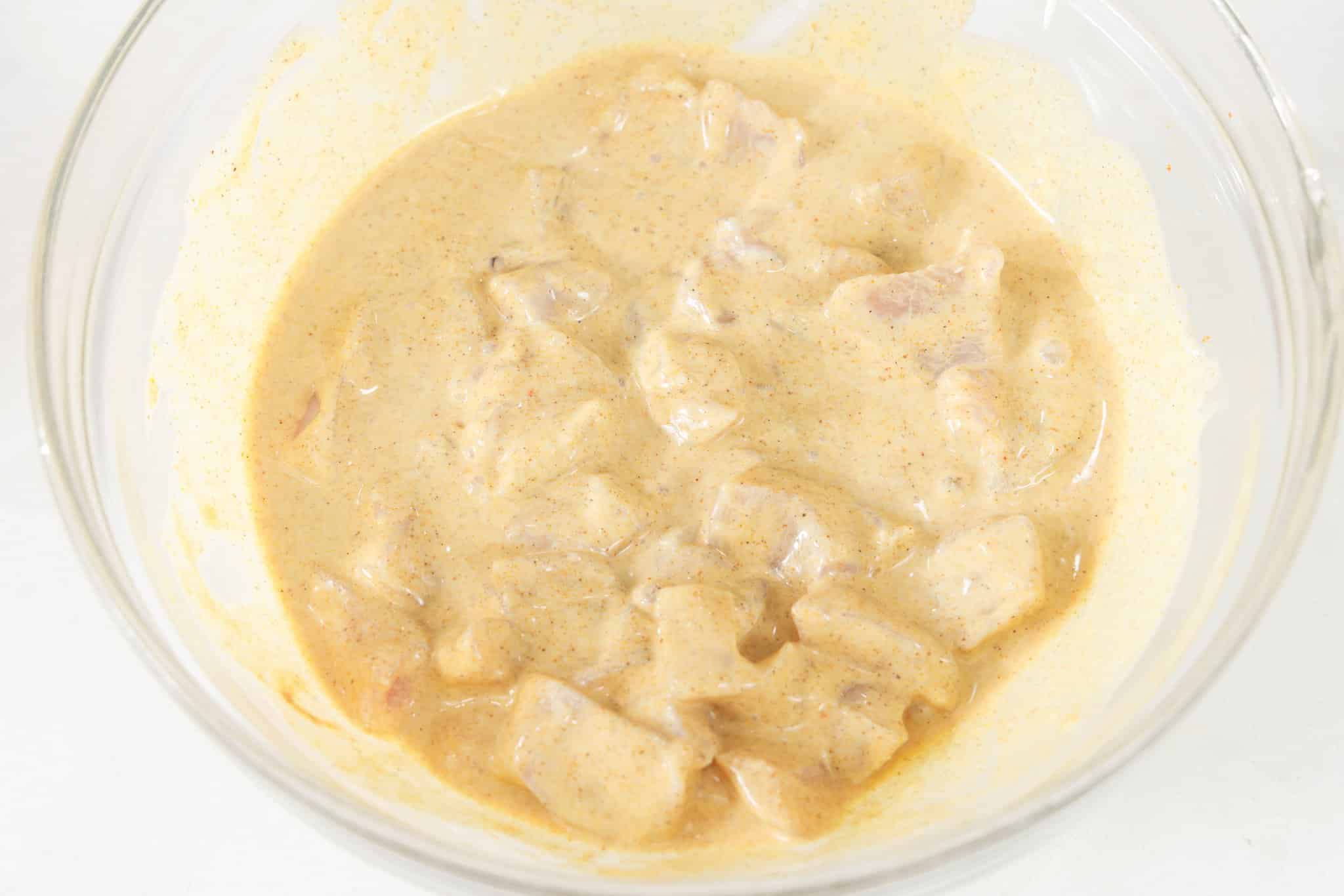 Marinating chicken in shawarma marinade.