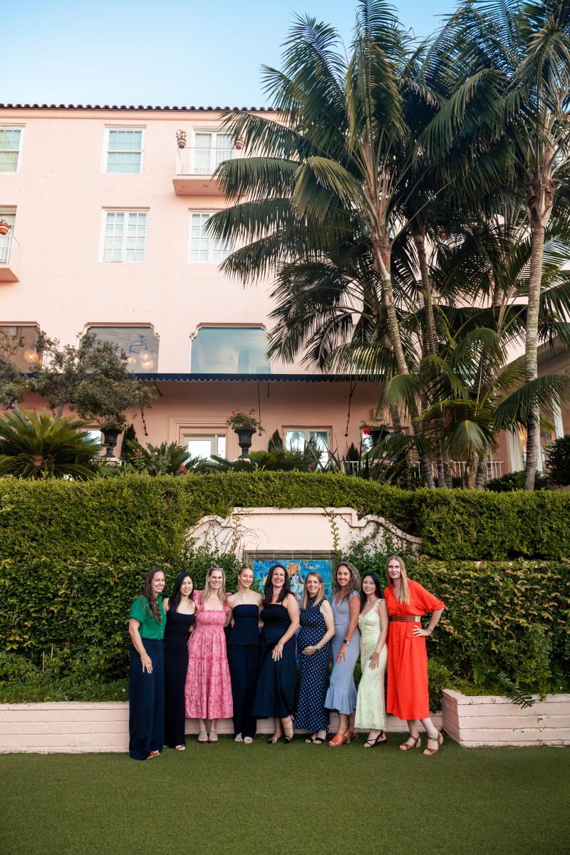 Fresh air retreat attendees standing in a row in front of bushes.