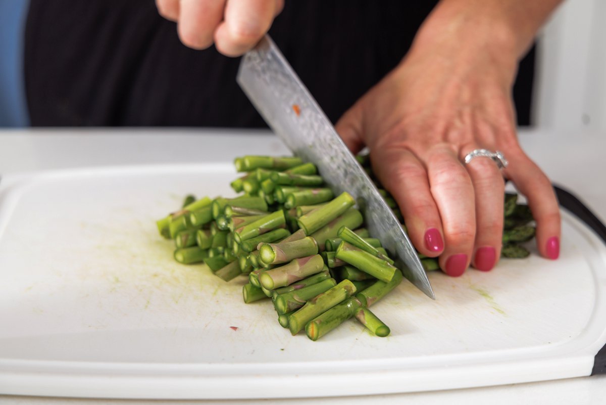Liz cutting asparagus spears into smaller pieces.