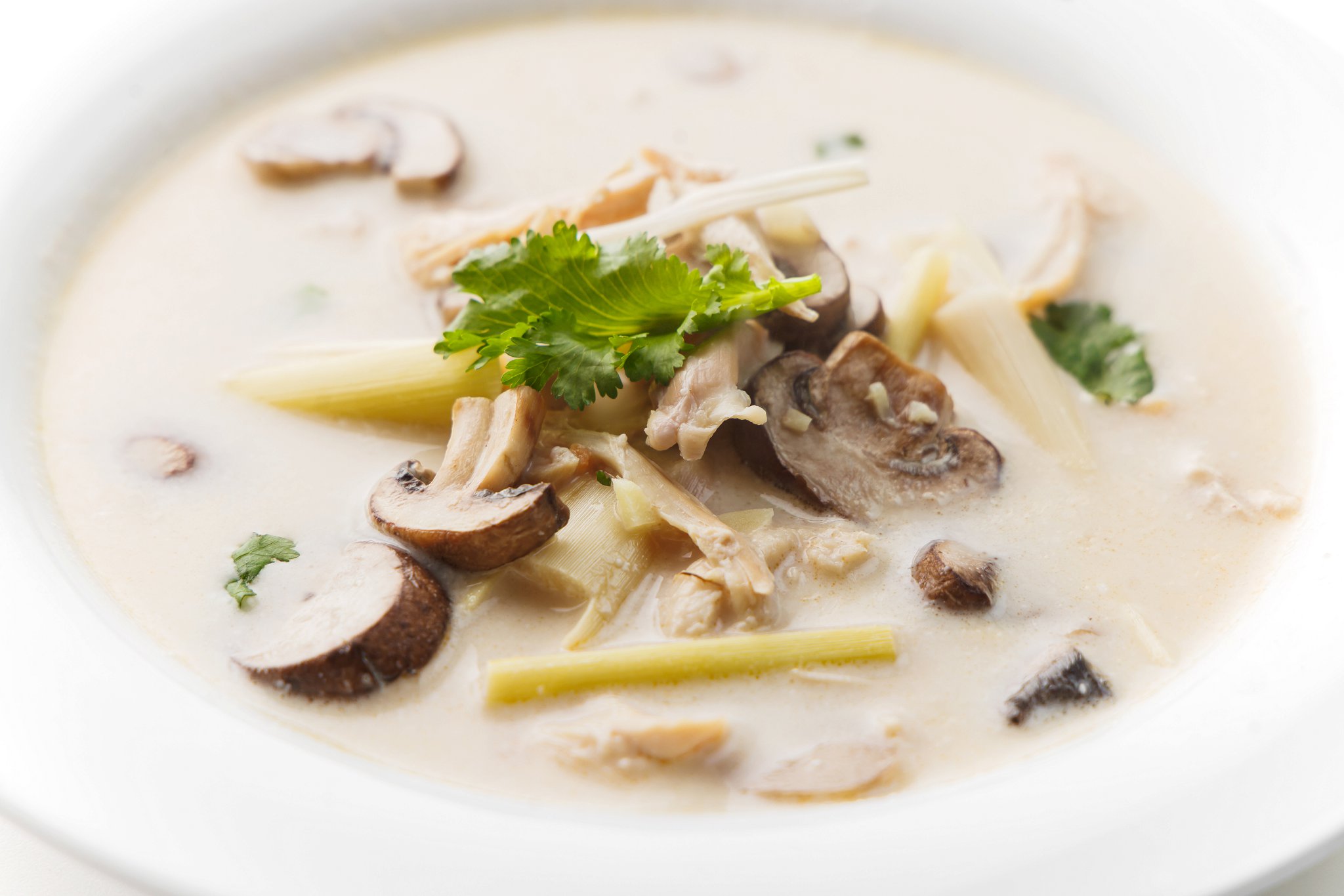 A bowl of tom kha gai thai chicken coconut soup.