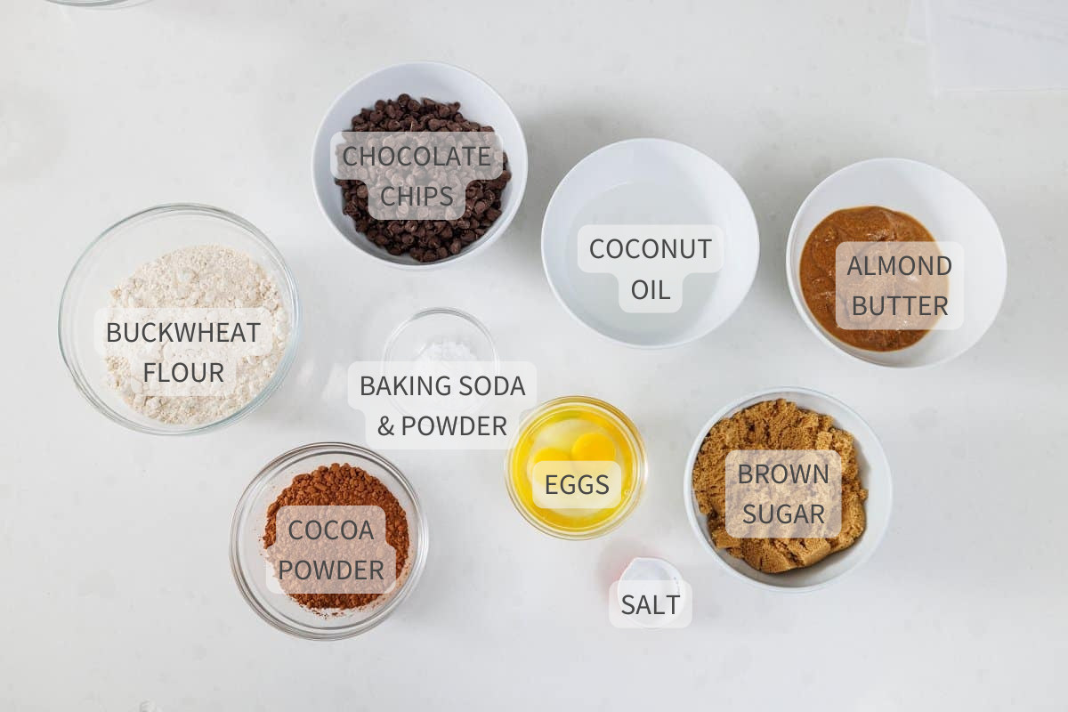 Labeled ingredients for buckwheat double dark chocolate brownie cookies on a white counter.